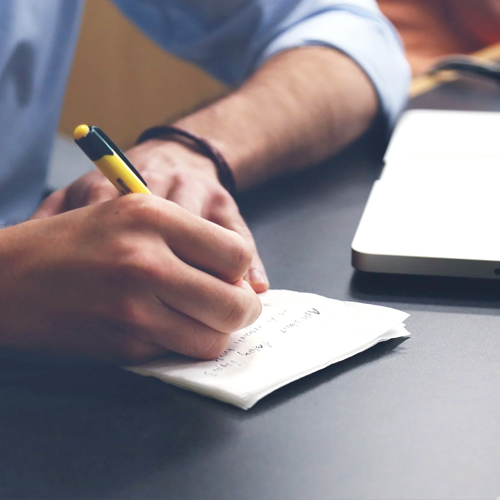 Man Writing on a piece of paper