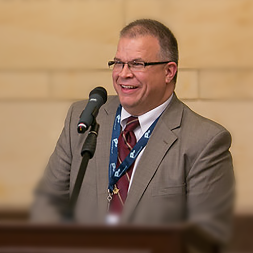 Shuan standing at a podium